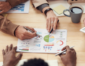 group meeting at table with charts